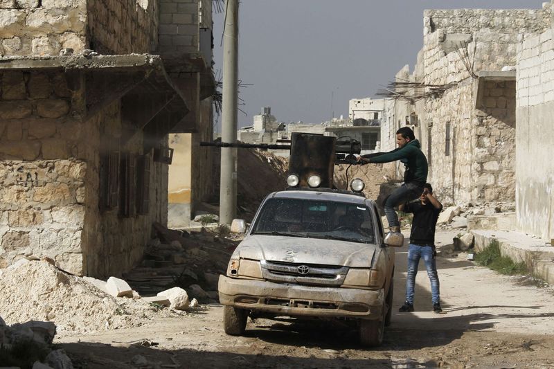 © Reuters. Group 16 fighters, part of the Free Syrian Army, fire a weapon during clashes with forces loyal to Syria's President Assad in Ashrafieh