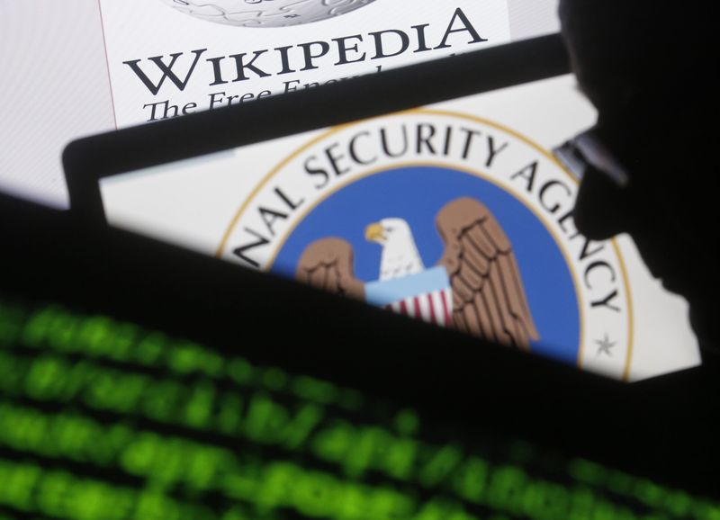 © Reuters. A man is seen near cyber code and the U.S. National Security Agency logo in this photo illustration taken in Sarajevo