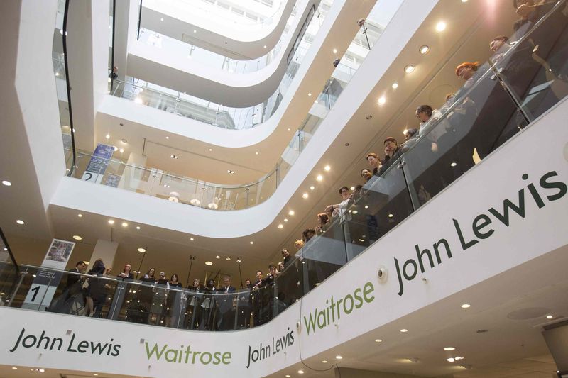 © Reuters. John Lewis and Waitrose employees wait for the announcement of their 2015 bonus in central London