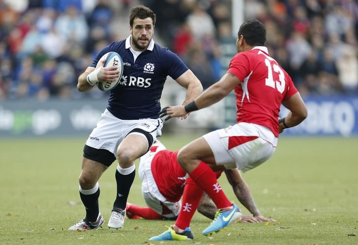 © Reuters. Scotland's Dunbar takes on Tonga's Piutau during their Autumn International rugby union match in Kilmarnock