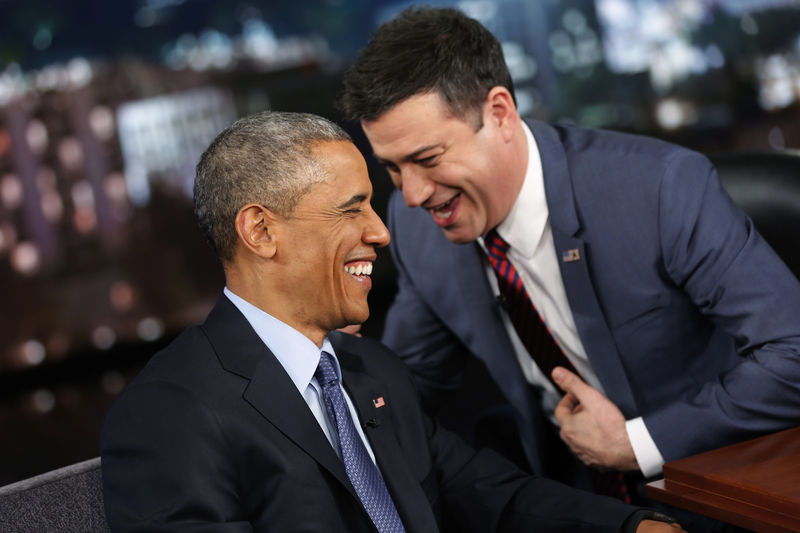 © Reuters. Obama laughs with show host Jimmy Kimmel during a commercial break in a taping of Jimmy Kimmel Live in Los Angeles