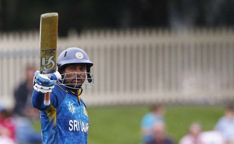 © Reuters. Sri Lankan batsman Dilshan acknowledges his century during the Cricket World Cup match against Scotland in Hobart