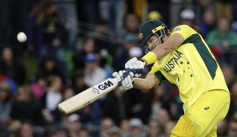 © Reuters. Australia's Shane Watson hits a four from the bowling of Scotland's Josh Davey during their Cricket World Cup match at the Bellerive Oval in Hobart