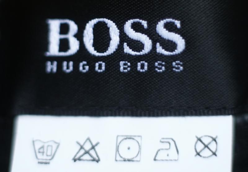 © Reuters. The logo of German fashion house Hugo Boss is seen on a clothing label at their outlet store in Mezingen near Stuttgart
