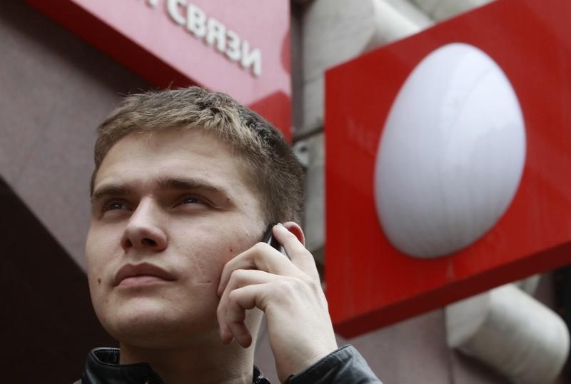 © Reuters. A man speaks on a mobile phone near an office of Russia's mobile phone operator MTS in Moscow