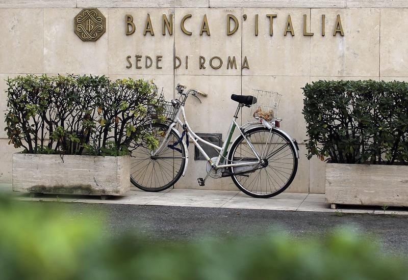 © Reuters. A bicycle is parked in front of a Bank of Italy sign in Rome