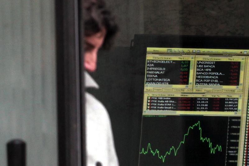 © Reuters. Man walks out Milan's stock exchange building in downtown Milan