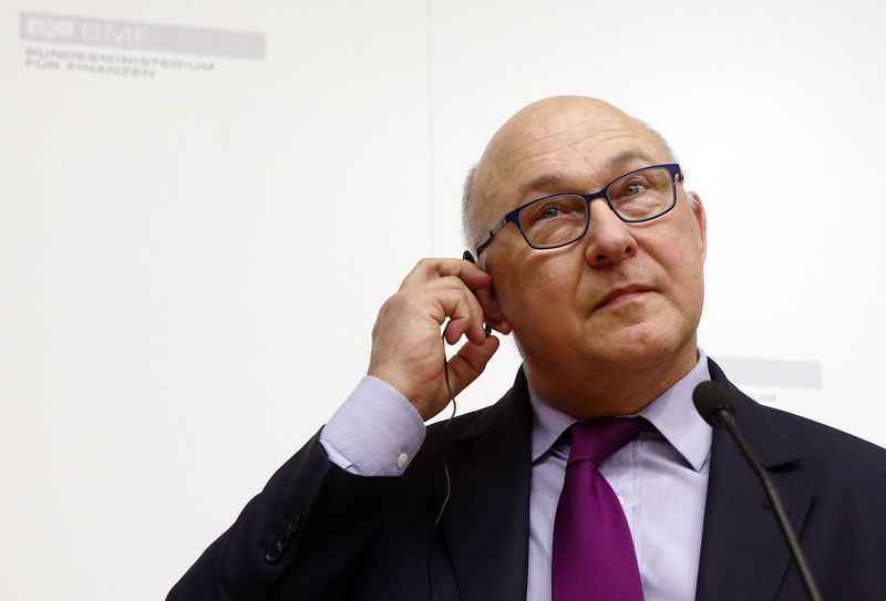 © Reuters. France's Finance Minister Sapin adjusts his earphone during a joint news conference with Austria's Finance Minister Schelling in Vienna