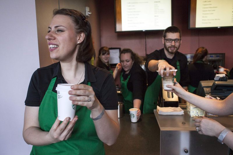 © Reuters. Starbucks baristas serve coffee during the company's annual shareholder's meeting in Seattle, Washington