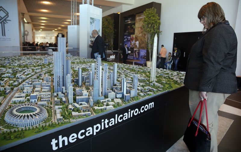 © Reuters. Delegate looks at a model of a planned new capital for Egypt during the final day of Egypt Economic Development Conference in Sharm el-Sheikh