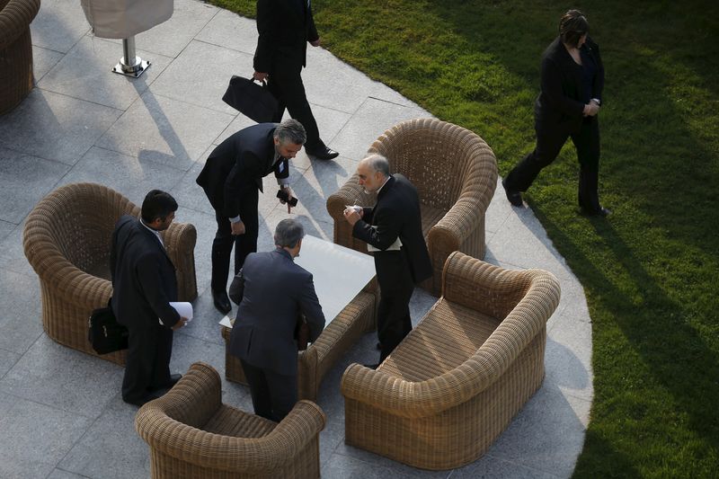 © Reuters. Head of the Atomic Energy Organization of Iran Salehi talks with his team before a negotiating session with the U.S. and the European Union over Iran's nuclear programme in Lausanne