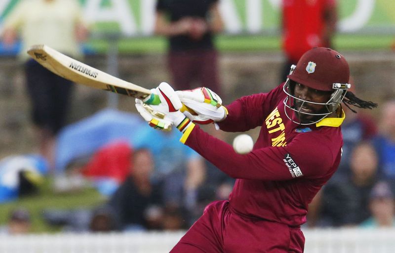 © Reuters. West Indies batsman Chris Gayle plays the ball to the boundary during their World Cup Cricket match against Zimbabwe in Canberra