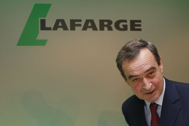 © Reuters. Bruno Lafont, Chairman and CEO of Lafarge, reacts as he takes his seat before announcing the company 2014 anual results at a news conference in Paris