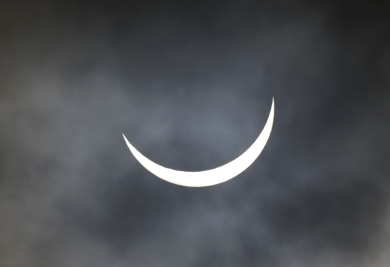 © Reuters. A partial solar eclipse is seen through cloud in Altrincham northern England