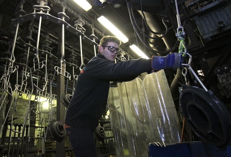 © Reuters. A worker at Belgian company Picanol works in a foundry at the factory's plant in Ypres