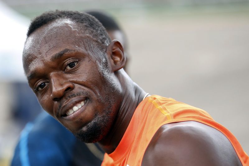 © Reuters. Jamaica's Usain Bolt smiles shortly after crossing the finish line first, in his first race of the season during the Gibson Relays in Kingston