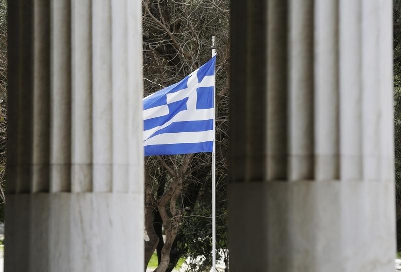 © Reuters. A Greek flag is seen through pillars at the Attalos arcade in Athens