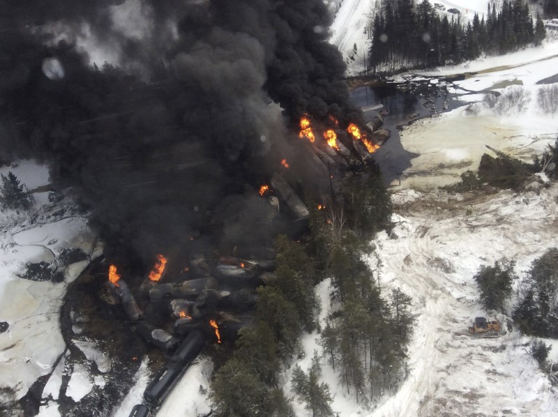 © Reuters. File handout photo shows smoke rising from fires caused by the derailment of a CN Railway train carrying crude oil near the northern Ontario community of Gogama
