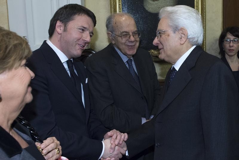 © Reuters. Il premier Matteo Renzi (a sinistra) stringe la mano al presidente della Repubblica Sergio Mattarella 