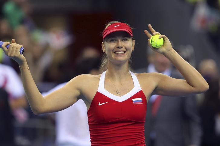 © Reuters. Sharapova of Russia celebrates a point against Agnieszka Radwanska of Poland during their Fed Cup World Group quarterfinal tennis match between Poland and Russia in Krakow