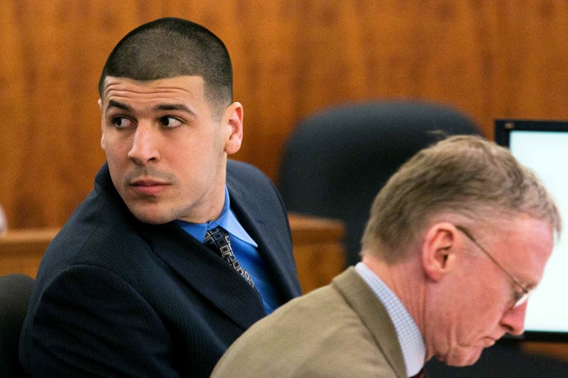 © Reuters. Former NFL player Aaron Hernandez looks over his shoulder during his murder trial at the Bristol County Superior Court in Fall River
