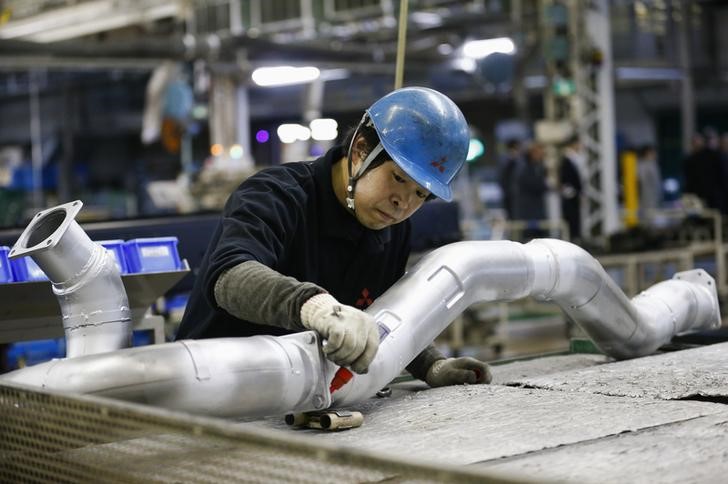 © Reuters. A man works at the assembly line of the MFTBC factory in Kawazaki