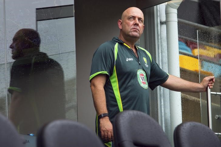 © Reuters. Australia's coach Darren Lehmann looks up at the sky as he stands on the balcony of the team dressing room before the scheduled start of the Cricket World Cup match between Australia and Bangladesh at the Gabba cricket ground in Brisbane