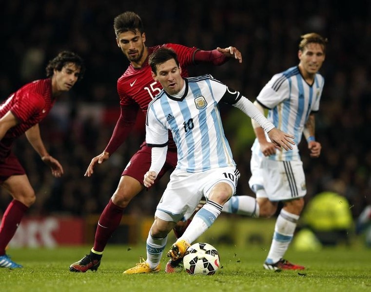 © Reuters. Argentina's Messi is challenged by Portugal's Gomes during their international friendly soccer match at Old Trafford in Manchester