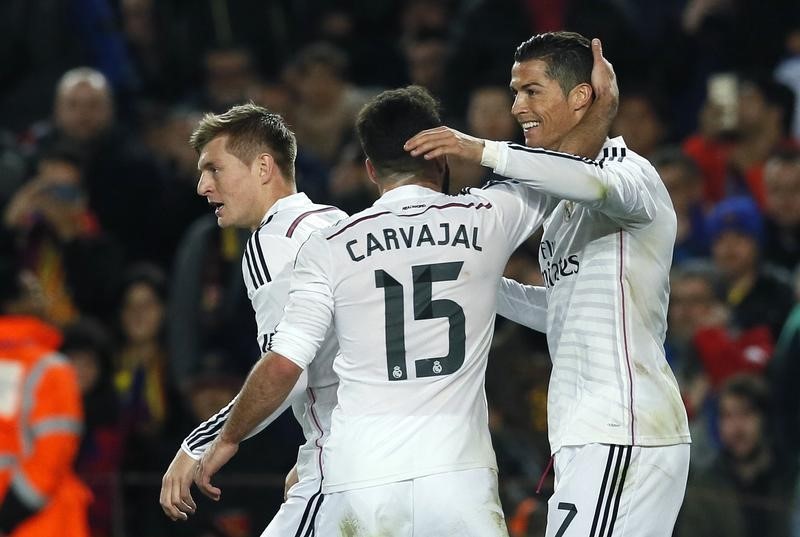 © Reuters. Real Madrid's Ronaldo is congratulated by his team mates Carvajal and Kroos after scoring a goal against Barcelona during their Spanish first division "Clasico" soccer match at Camp Nou stadium in Barcelona