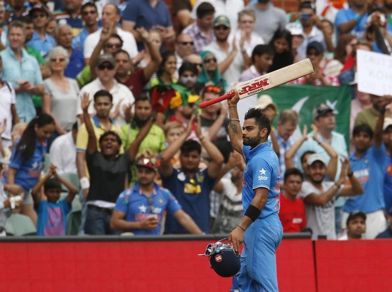 © Reuters. India's batsman Kohli acknowledges the crowd as he walks off the pitch upon his dismissal during their Cricket World Cup match against Pakistan in Adelaide