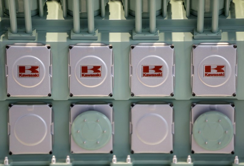 © Reuters. File photo of the logos of the Kawasaki Heavy Industries are seen on a model of the company's green gas engine, at their Tokyo head office 