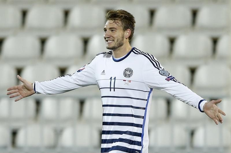 © Reuters. Denmark's Bendtner celebrates goal against Serbia during Euro 2016 qualifier in Belgrade 