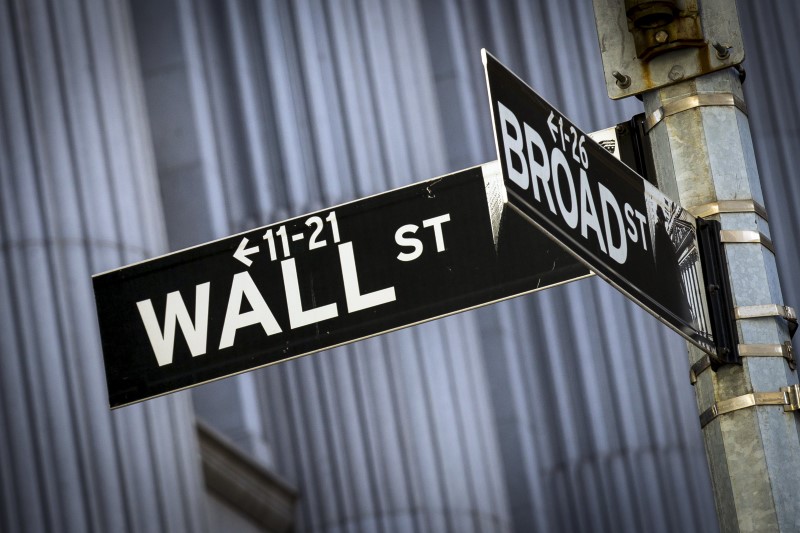 © Reuters. Street signs for Wall St. and Broad St. hang at the corner outside the New York Stock Exchange 