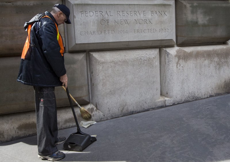 © Reuters. A maintenance worker sweeps outside  The New York Federal Reserve Bank in New York's financial district 