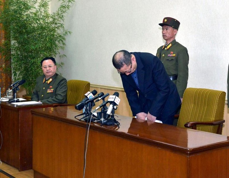 © Reuters. Handout photo of one of the two men whom North Korea identified as being South Korean and accused of being a spy for South Korea bowing during a news conference in Pyongyang