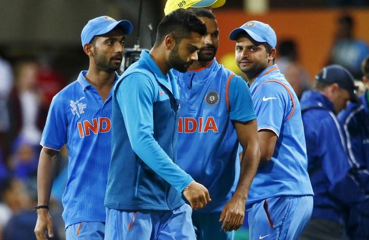 © Reuters. India's Virat Kohli and team mates react after Australia won their Cricket World Cup semi-final match in Sydney