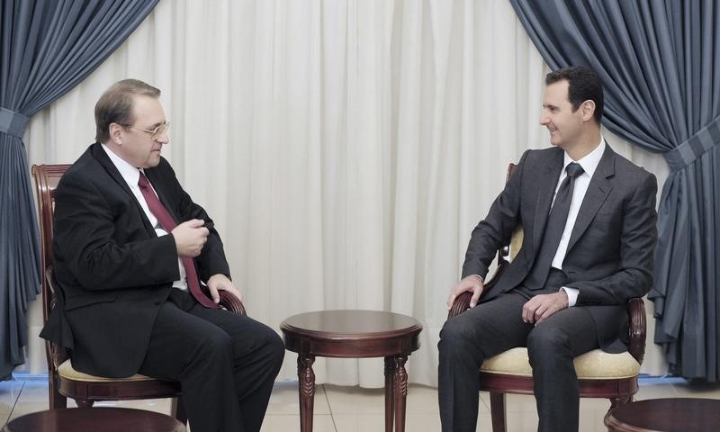 © Reuters. Syria's President Bashar al-Assad meets Russia's Deputy Foreign Minister Mikhail Bogdanov in Damascus