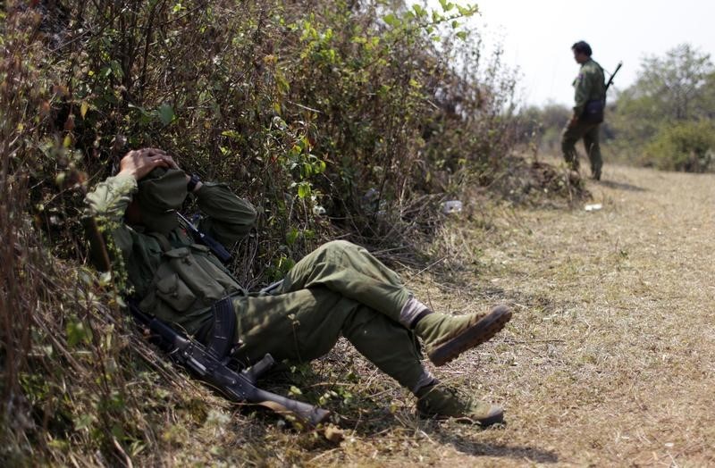 © Reuters. Rebel soldier of Myanmar National Democratic Alliance Army (MNDAA) rests near a military base in Kokang region