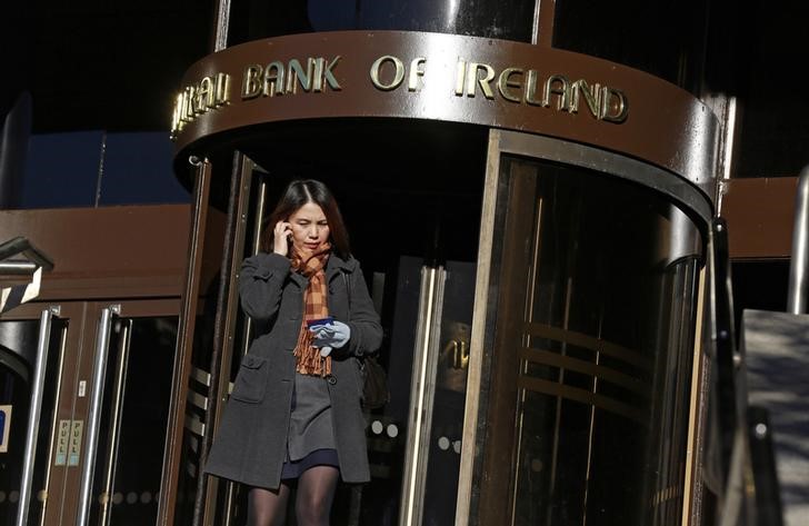 © Reuters. A woman leaves the Central Bank of Ireland in the Temple Bar area of Dublin