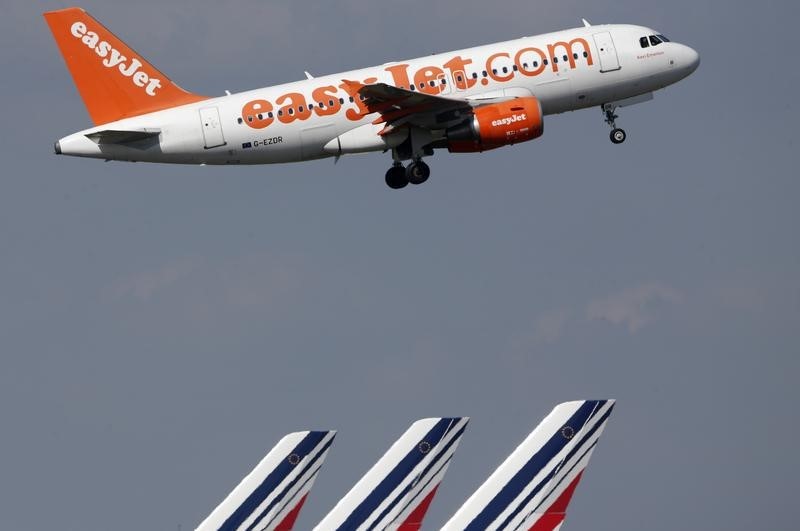 © Reuters. An easyJet aircraft takes-off past Air France plane tails at the Charles-de-Gaulle airport