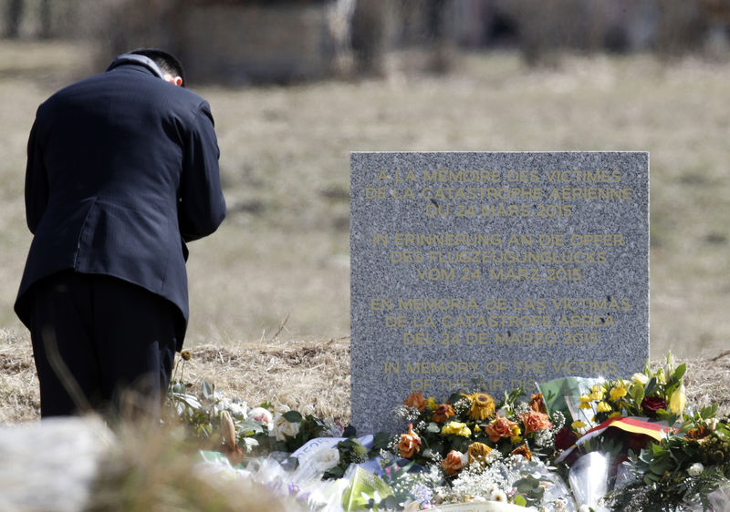 © Reuters. A man pays his respects at the memorial for the victims of the air disaster in the village of Le Vernet