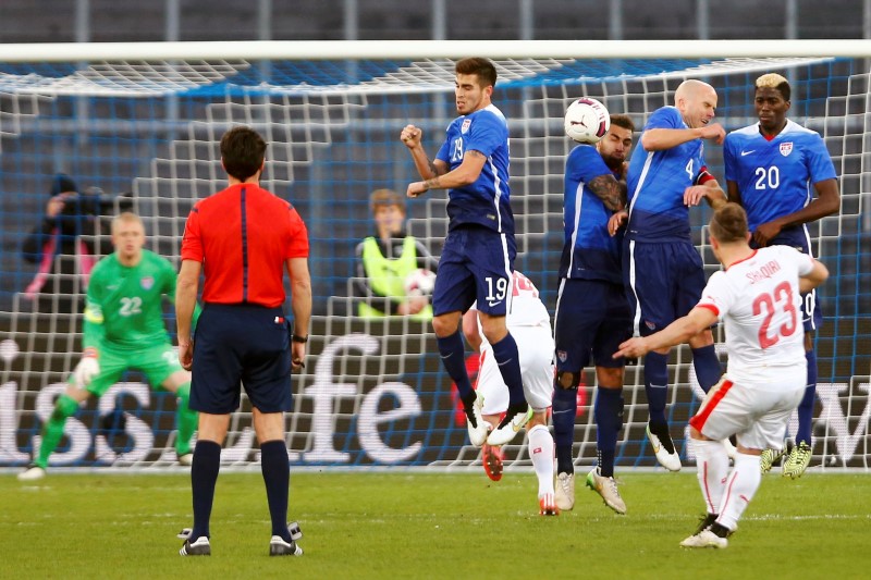 © Reuters. Players of the U.S defend a free kick of Shaqiri of Switzerland during their international friendly soccer match at the Letzigrund Stadium in Zurich