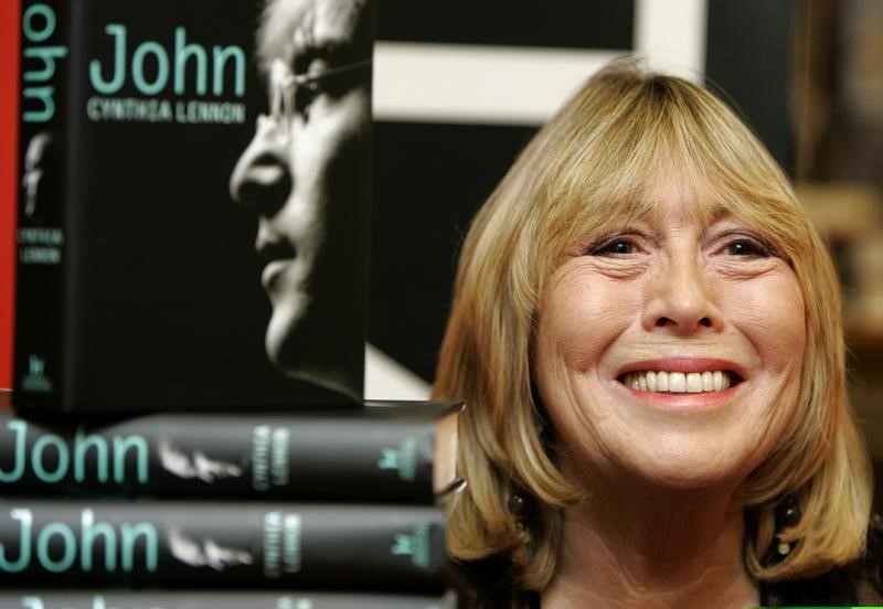 © Reuters. Cynthia Lennon, first wife of former Beatle John Lennon, poses with copies of her newly published bi..