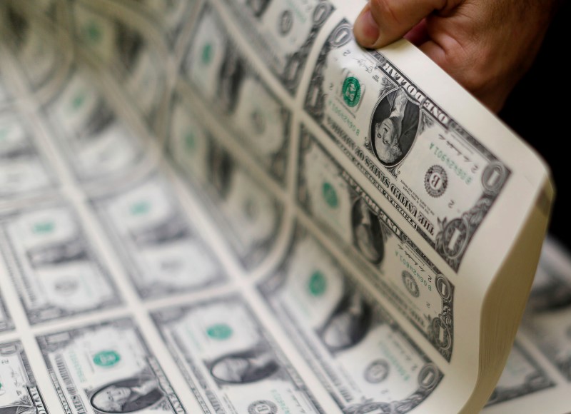 © Reuters. File photo of the United States one dollar bills curled and inspected during production at the Bureau of Engraving and Printing in Washington