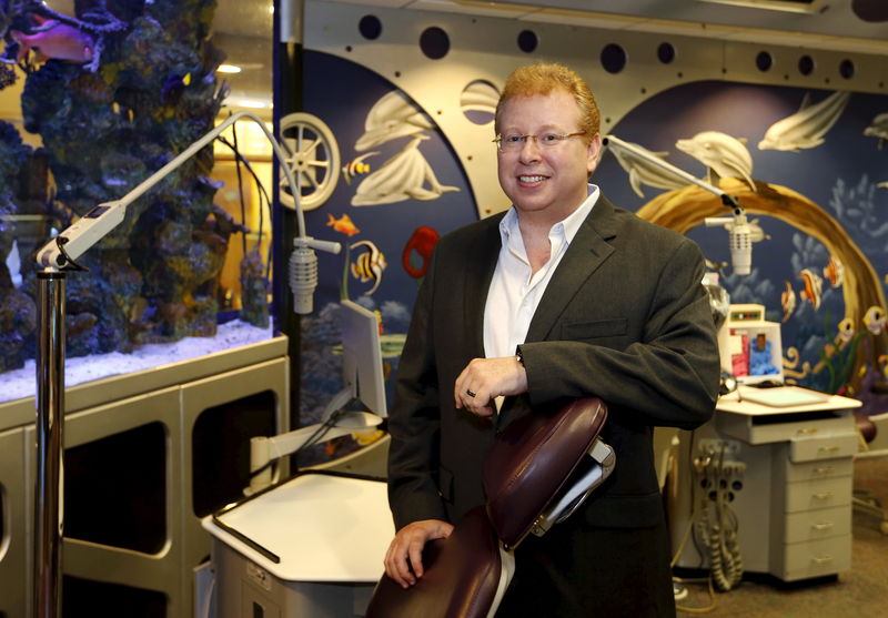 © Reuters. Orthodontist Larry Kawa poses at his office in Boca Raton, Florida 