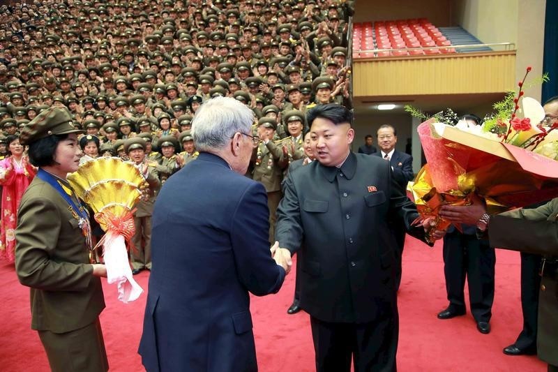 © Reuters. North Korean leader Kim Jong Un shakes hands during a photo session with participants in the 7th National Conference of Sportspersons