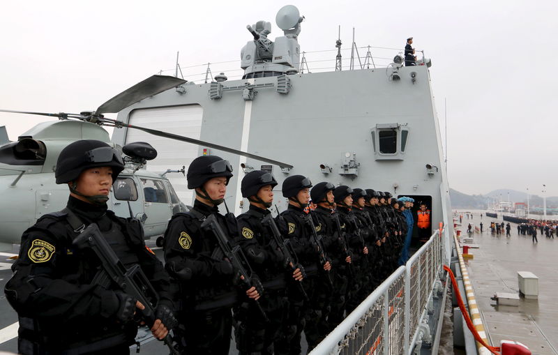 © Reuters. Soldiers of Chinese People's Liberation Army stand on deck before the fleet sets out for Aden, Yemen from Zhoushan