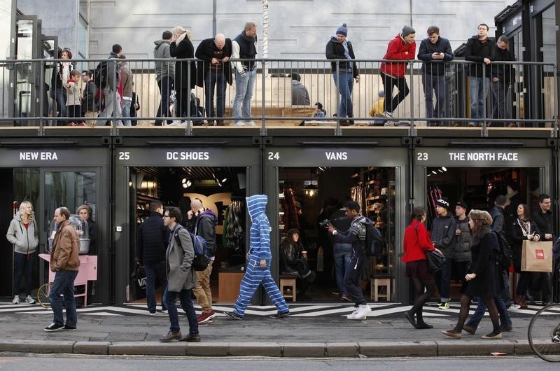 © Reuters. People walk past Boxpark Shoreditch shopping mall on its opening day in London