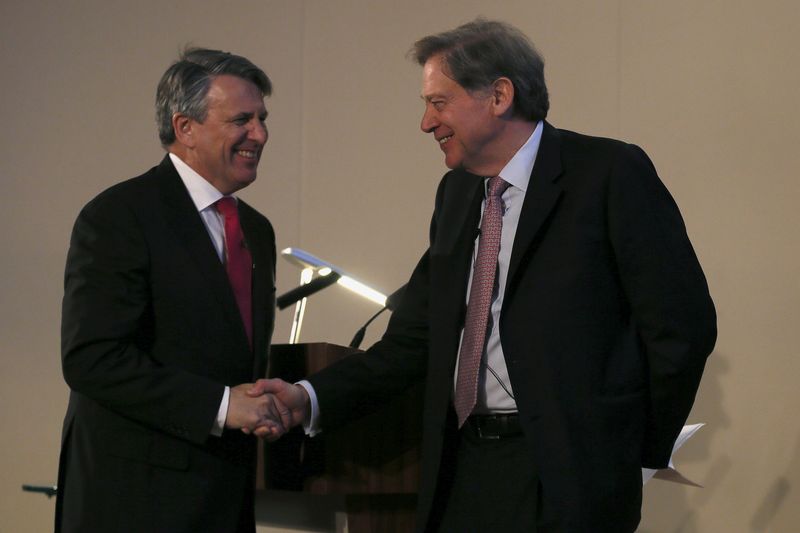 © Reuters. Van Beurden, chief executive officer of Royal Dutch Shell, shakes hand with Gould, chairman of the BG Group, during a news conference at the London Stock Exchange