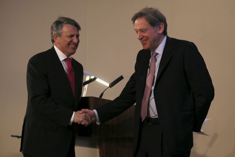 © Reuters. Van Beurden, chief executive officer of Royal Dutch Shell, shakes hand with Gould, chairman of the BG Group, during a news conference at the London Stock Exchange